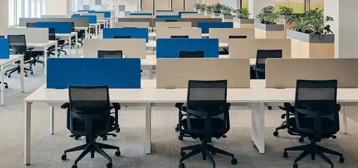 Modern open-plan office space featuring clean workstations, ergonomic chairs, and sanitized carpets provided by professional office cleaning services in Akron, OH.