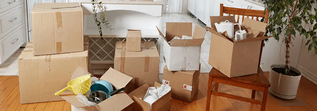 Packed moving boxes and household items in a kitchen before move-out or move-in cleaning, Akron, OH.